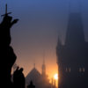 Silhouette sculpture Prague's Charles Bridge at dawn